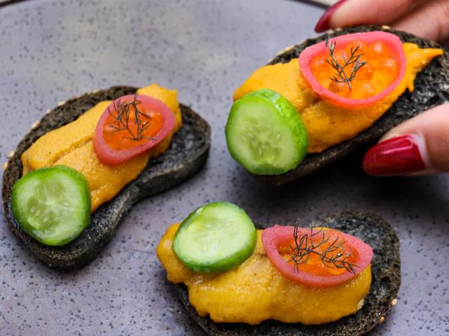 Oyster with tarama on squid ink cracker. Picture: Jenifer Jagielski