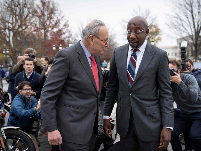 WASHINGTON, DC - DECEMBER 7: Senate Majority Leader Chuck Schumer (D-NY) walks outside the U.S. Capitol to greet Sen. Raphael Warnock (D-GA) as he returns to Washington after winning the Georgia runoff election December 7, 2022 in Washington, DC. Warnock defeated Georgia Republican Senate candidate Herschel Walker.   Drew Angerer/Getty Images/AFP (Photo by Drew Angerer / GETTY IMAGES NORTH AMERICA / Getty Images via AFP)