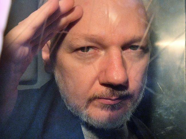 WikiLeaks founder Julian Assange gestures from the window of a prison van as he is driven out of Southwark Crown Court in London. Picture: AFP