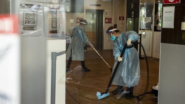 Cleaners in full PPE disinfect the Holiday Inn hotel. Picture: Getty