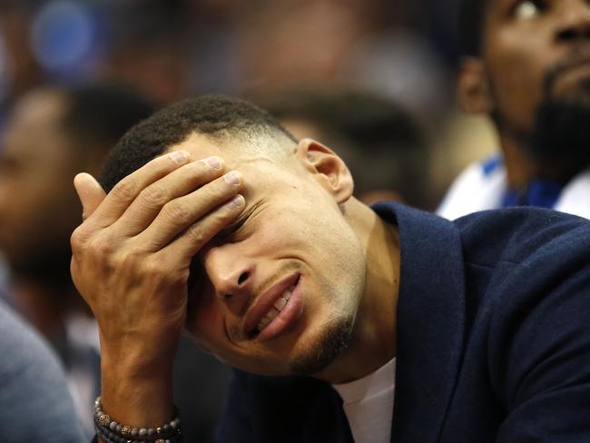 Golden State Warriors Stephen Curry, left, and Kevin Durant look on from the bench as the Warriors play the Dallas Mavericks during the second half of an NBA basketball game, Saturday, Nov. 17, 2018, in Dallas. The Mavericks won 112-109. (AP Photo/Ron Jenkins)