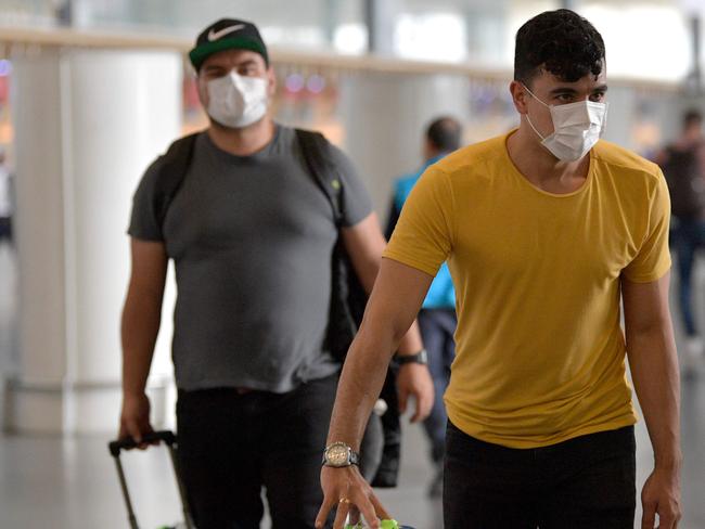 People wear protective face masks at El Dorado airport in Bogota. Picture: AFP