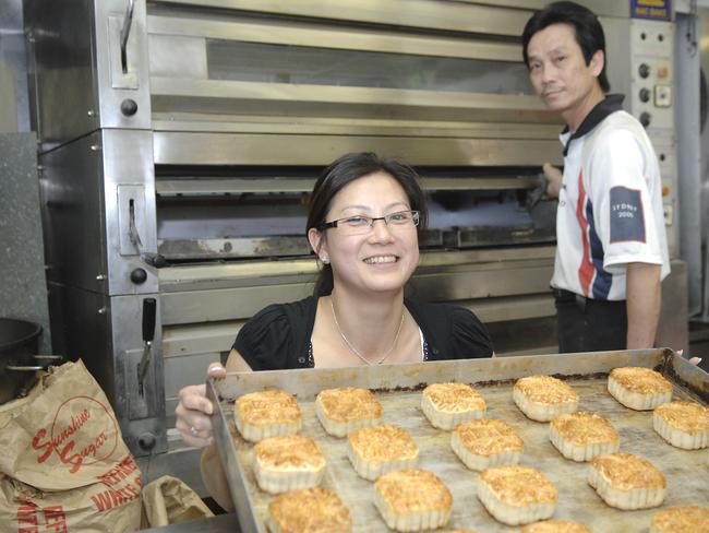 Christine Giang, manager of the ''An Phat Cake Shop'' and Le Nguyen, baker at work, busy baking all of the Moon cakes for the Cabramatta Moon Festival.