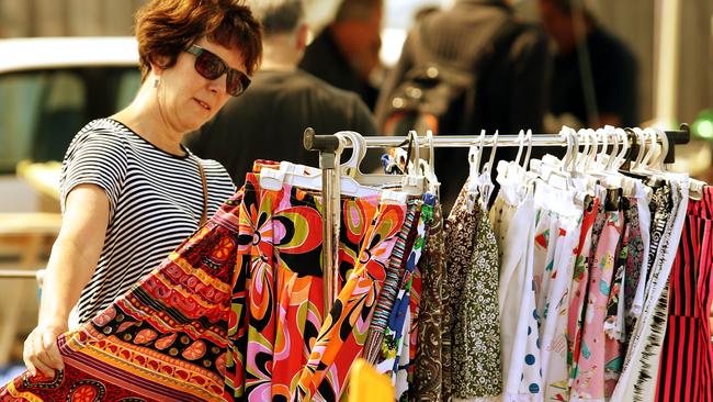 A woman checks out a clothing rack at Oakleigh Market. Picture: Mark Wilson