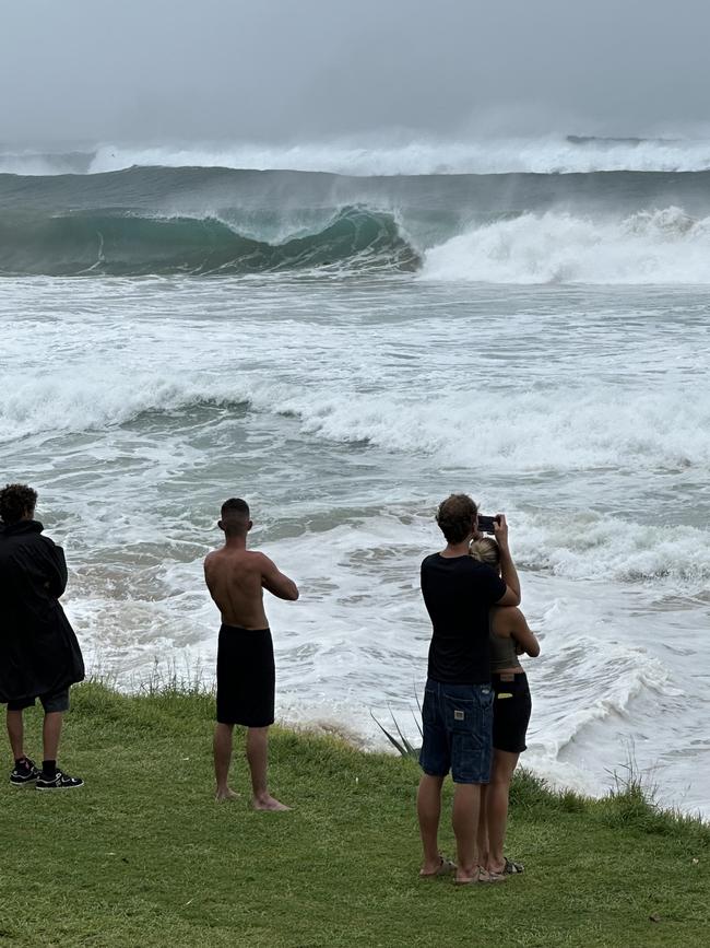 Kids watch on as a few brave surfers braved the huge swell.