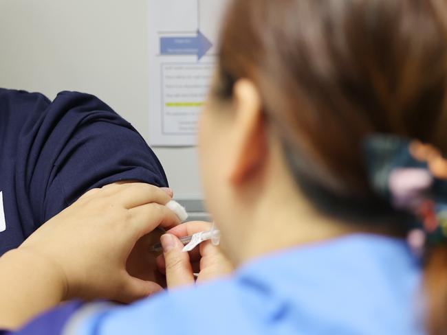 ADELAIDE, AUSTRALIA - NewsWire Photos March 17, 2021: Nepalese nurse Durga Basnet receives the Covid vaccine by Nga Tran at the Lyell McEwan Hospital in Elizabeth, Adelaide. Picture: NCA NewsWire / David Mariuz