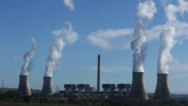 05/05/2023. Gerard Spinks, 59, Bayswater plant assistant manager, has worked in coal fired plants for more than four decades and is concerned about what will happen to workers as the economy detransitions. Photographed with  Bayswater Power station in the background, 15 minutes south of Muswellbrook in NSW. Britta Campion / The Australian