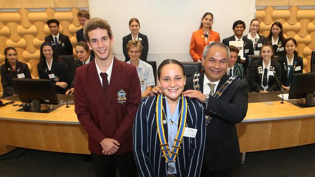 Mayor Tom Tate puts chain around junior mayor Khyia Miller, watched on by outgoing junior mayor Caelan Pascoe. Picture Glenn Hampson