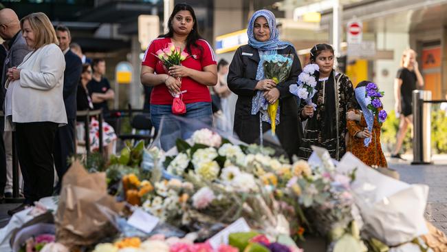Survivors, victim’s family members, dignitaries and members of the public lay flowers at a memorial in Oxford Street Mall in Bondi Junction to mark the one year anniversary of the Bondi Westfield stabbings. Picture: Julian Andrews