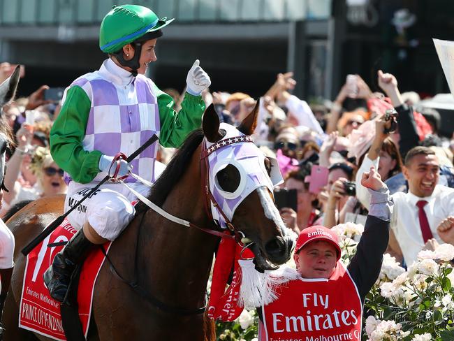 Michelle Payne celebrates after Tuesday’s Cup win with her brother Steven, who works as a strapper.   Picture: George Salpigtidis