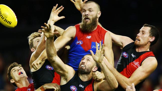 Max Gawn hits a pack of Essendon defenders.