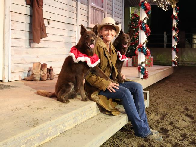 Christmas is in the air at Outback Spectacular. Heidi Mackay takes a break from rehearsals on a very festive set with canine stars Red and Oi. Picture: Glenn Hampson.