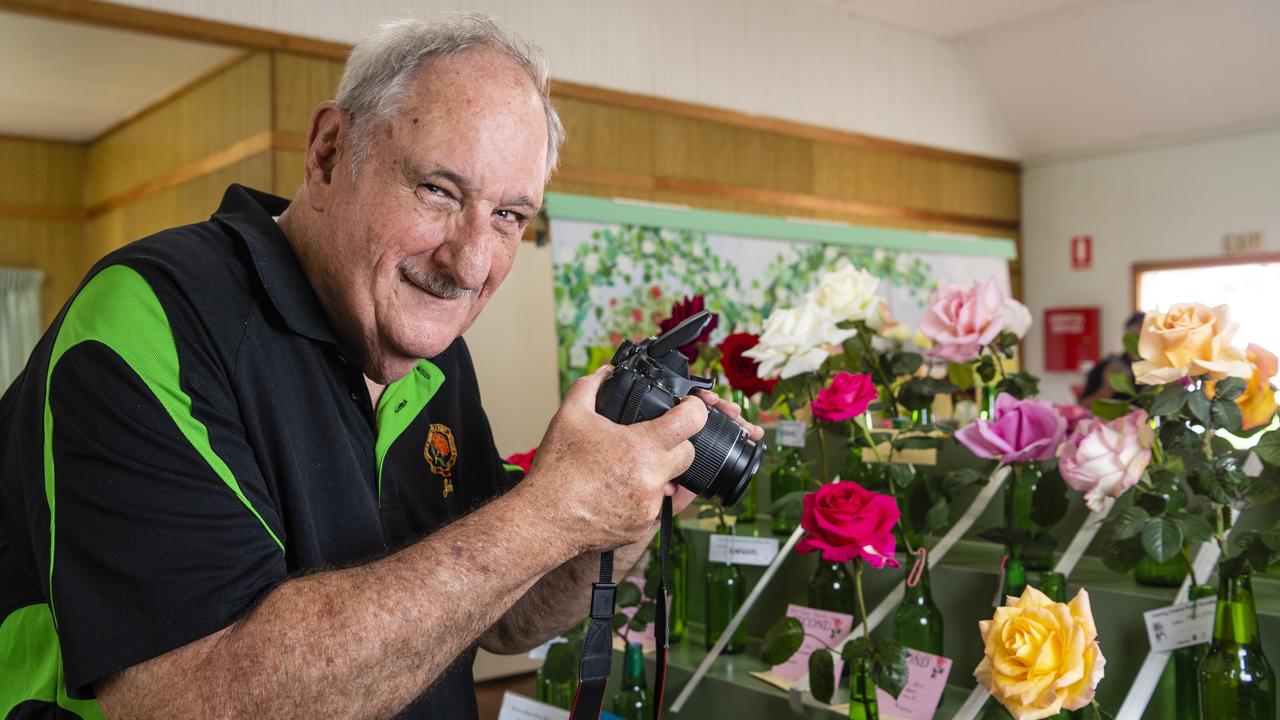 John Keays of Brisbane taking photos of the roses in the 2022 Spring Champion Rose Show at the Rose Cottage in the Queensland State Rose Garden, Saturday, October 8, 2022. Picture: Kevin Farmer