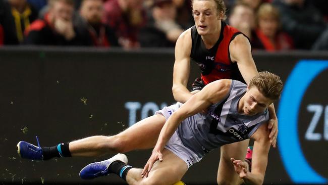 Xavier Duursma beats Essendon’s Mason Redman to the footy. Picture: Michael Willson/AFL Photos via Getty Images