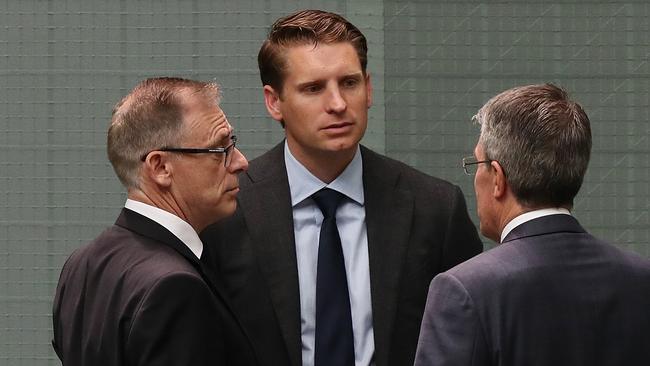 Parliamentary Joint Committee on Intelligence and Security members Anthony Byrne, Andrew Hastie and Mark Dreyfus talking in the House of Representatives Chamber, Parliament House in Canberra. Picture: Kym Smith