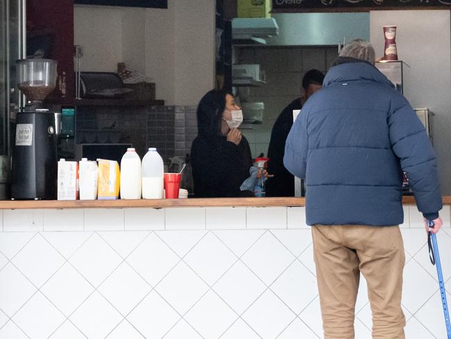 SYDNEY, AUSTRALIA - NewsWire Photos June 28, 2021: A customer waits outside a coffee shop that swapped to takeaway only in line with new COVID-19 lockdown restrictions. Picture: NCA NewsWire / James Gourley