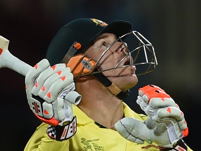 Australian cricketer David Warner follows the ball after playing a shot at the Bellerive Oval during the 2015 Cricket World Cup Pool A match between Australia and Scotland in Hobart on March 14, 2015. AFP PHOTO / INDRANIL MUKHERJEE -- IMAGE RESTRICTED TO EDITORIAL USE - STRICTLY NO COMMERCIAL USE--