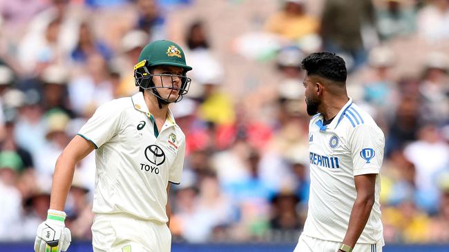 Australia's Sam Konstas (L) chats with India's Mohammed Siraj on day one of the fourth cricket Test match between Australia and India at the Melbourne Cricket Ground (MCG) in Melbourne on December 26, 2024. (Photo by Martin KEEP / AFP) / -- IMAGE RESTRICTED TO EDITORIAL USE - STRICTLY NO COMMERCIAL USE --