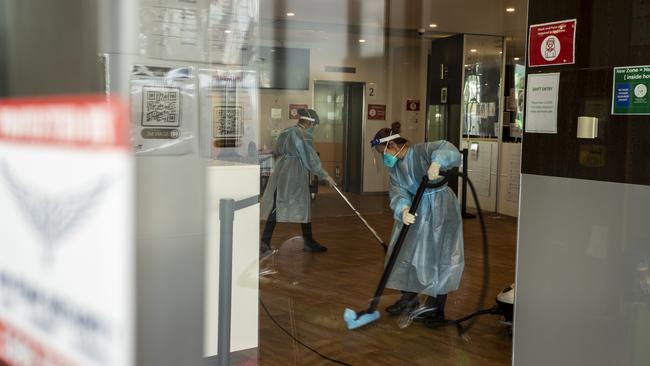 Cleaners are seen wearing full PPE while working at the disinfection of the Holiday Inn hotel on February 10, 2021 in Melbourne, Australia. (Photo by Diego Fedele/Getty Images)