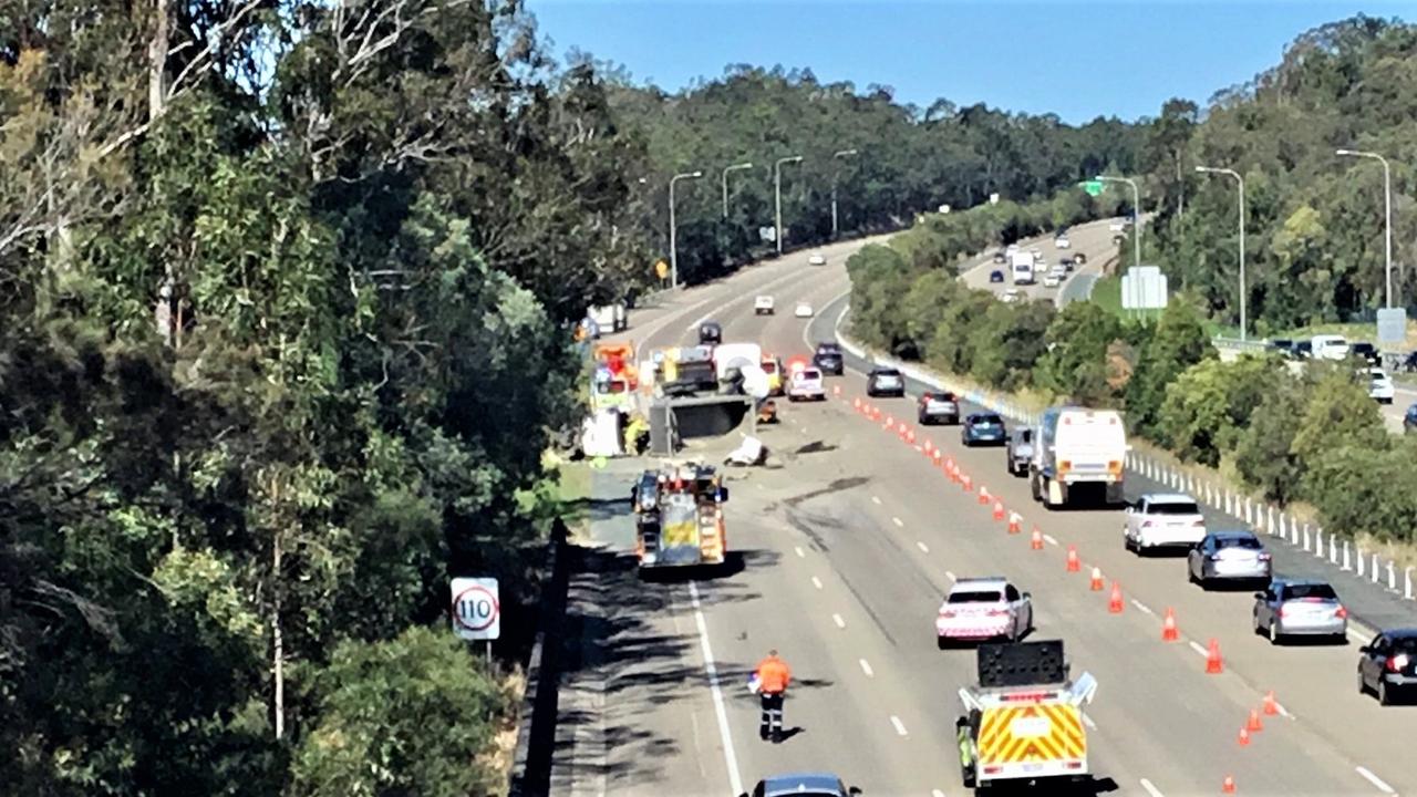 Motorists are facing 50-minute delays after two trucks crashed and rolled over on the M1 south of Brisbane. Picture: QAS