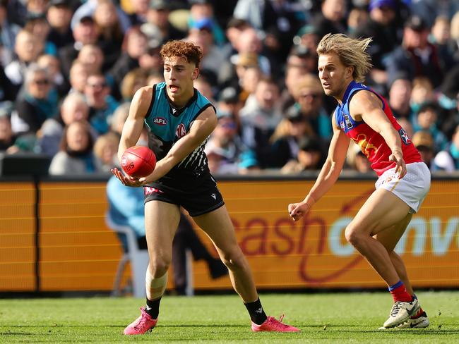 Debutant Logan Evans had a baptism of fire in an under-siege defence. Picture: Sarah Reed/AFL Photos via Getty Images