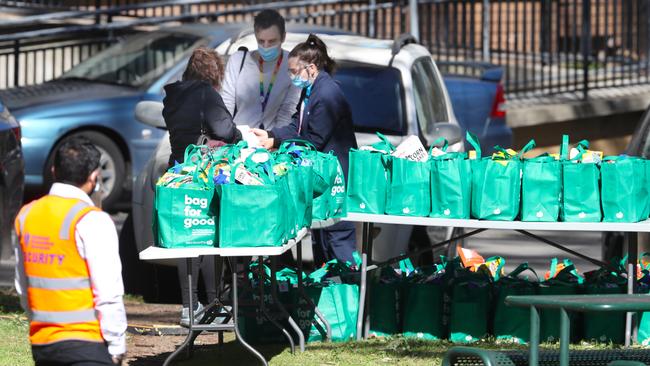 Bags of groceries are given out to Alfred St residents who volunteer to get tested. Picture: David Crosling