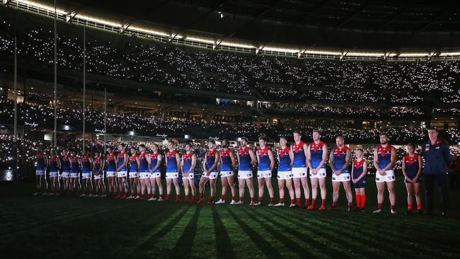 Melbourne players observe a minute’s silence on Anzac Day eve in 2019.