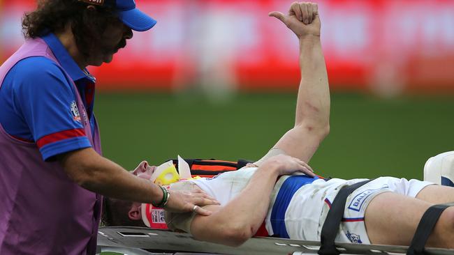 Mitch Honeychurch gives the thumbs up to the spectators while being carted from the field. Picture: Getty Images