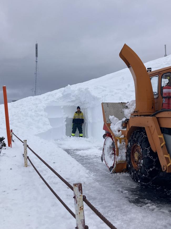 A worker stands in the snow showing the depth on Pinnacle Road near the top of Mt Wellington. Picture: Hobart City Council