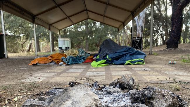 A fire pit and sleeping equipment near one of the shelters provided to people sleeping rough at the Safer Places to Gather campsite. Picture: Supplied