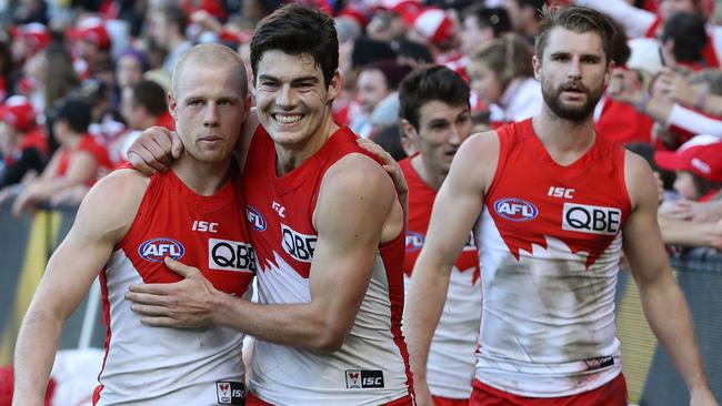 Zak Jones, George Hewett and Harrison Marsh celebrate the Swans’ win.