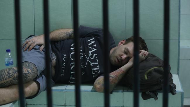 Joshua James Baker sleeping at the Denpasar Prosecutor Office in Denpasar Bali o before he is taken to Kerobokan prison. Picture: Rizal Fanany