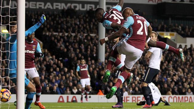 West Ham United's English midfielder Michail Antonio (C) scores.