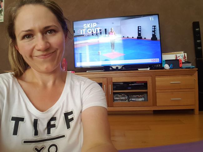Amanda does the exercise program in her living room. Picture: Supplied