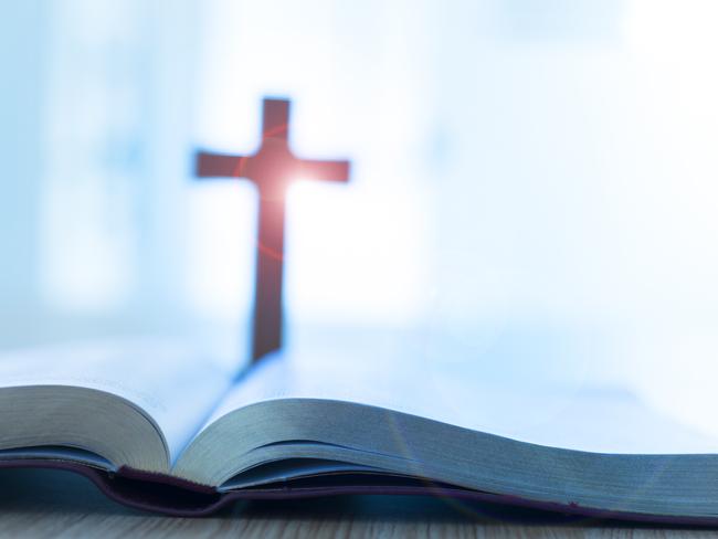 Bible and cross on desk. Cult Religion generic