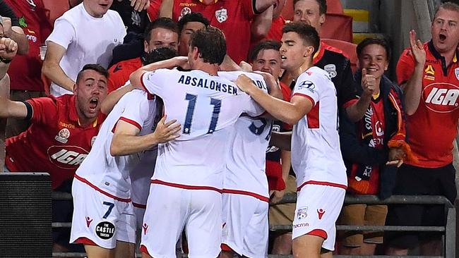 Adelaide United players celebrate with fans after Ryan Kitto’s equaliser in the 2-1 win over Brisbane Roar at Suncorp Stadium. (Photo by Ian Hitchcock/Getty Images)