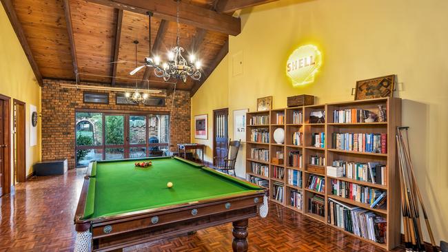 The large pool table in one of the living rooms.