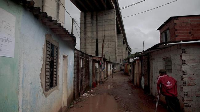 Child prostitutes as young as 11 work in this slum which lines the fence of the 2016 Olympic football stadium in Sao Paulo. Picture: Jota Roxo