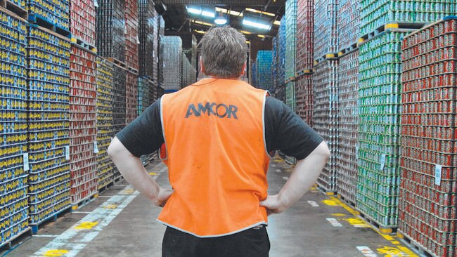 An Amcor employee looks down an aisle of stacked aluminium beverage cans ready for distribution. Picture: Carla Gottgens/Bloomberg News.