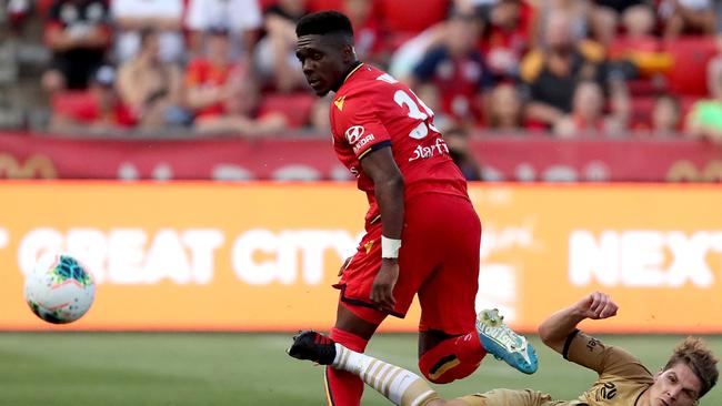 Adelaide United’s Al Hassan Toure tackled by Western Sydney’s Pirmin Schwegler at Coopers Stadium. (AAP Image/James Elsby)