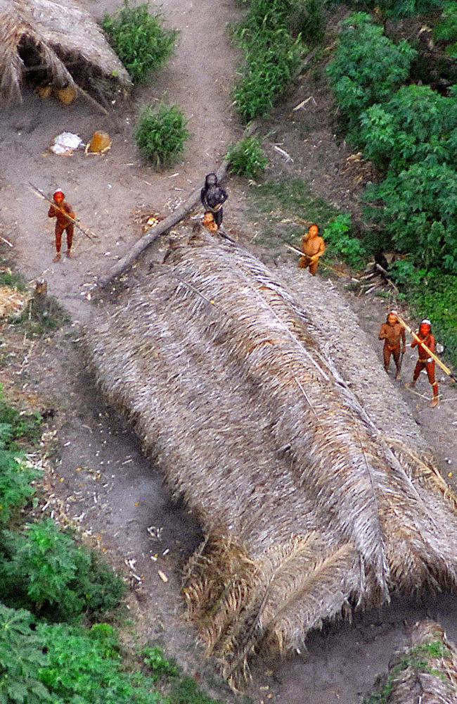 Picture released by the Brazilian Indian Protection Foundation (FUNAI) showing members of the uncontacted Moxihatetema tribe, with their bodies painted in bright red staring at the aircraft from which the pictures were taken, in the Amazon region in the Brazilian-Peruvian border.