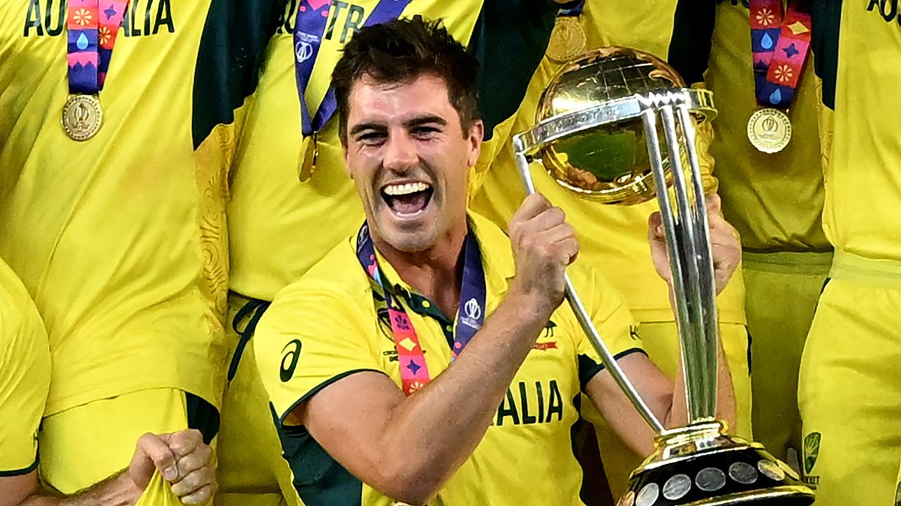 Australia's captain Pat Cummins celebrates with the trophy after winning the 2023 ICC Men's Cricket World Cup one-day international (ODI) final match against India at the Narendra Modi Stadium in Ahmedabad on November 19, 2023. (Photo by Sajjad HUSSAIN / AFP) / -- IMAGE RESTRICTED TO EDITORIAL USE - STRICTLY NO COMMERCIAL USE --