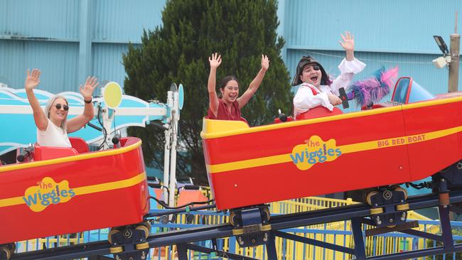 Test riding the new Wiggles Big Red Boat ride are Captain Feathersword with Dreamworld staff members Homare Atkinson and Casey Barton. Picture Glenn Hampson