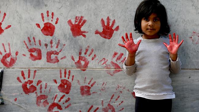 Protesters leave red paint hand prints on a pillar during a protest outside the South Australian Parliament in Adelaide, November 2019. Picture: AAP