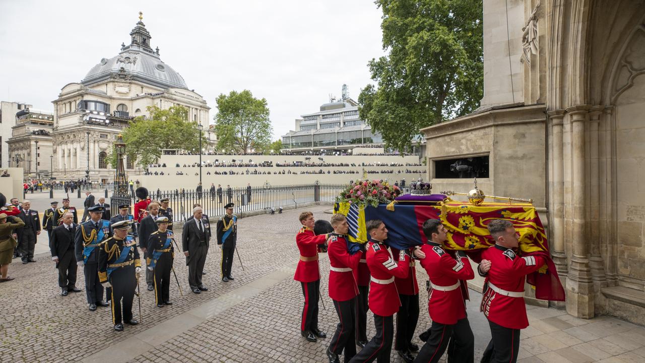 Prince William, Prince Harry, King Charles III, Princess Anne, Prince Andrew, and Prince Edward walk behind The Queen's funeral cortege.