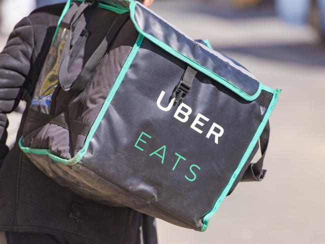 MOSCOW - APR 23: Worker with Uber Eats bicycle and a bag in a street of Moscow on April 23. 2018 in Russia