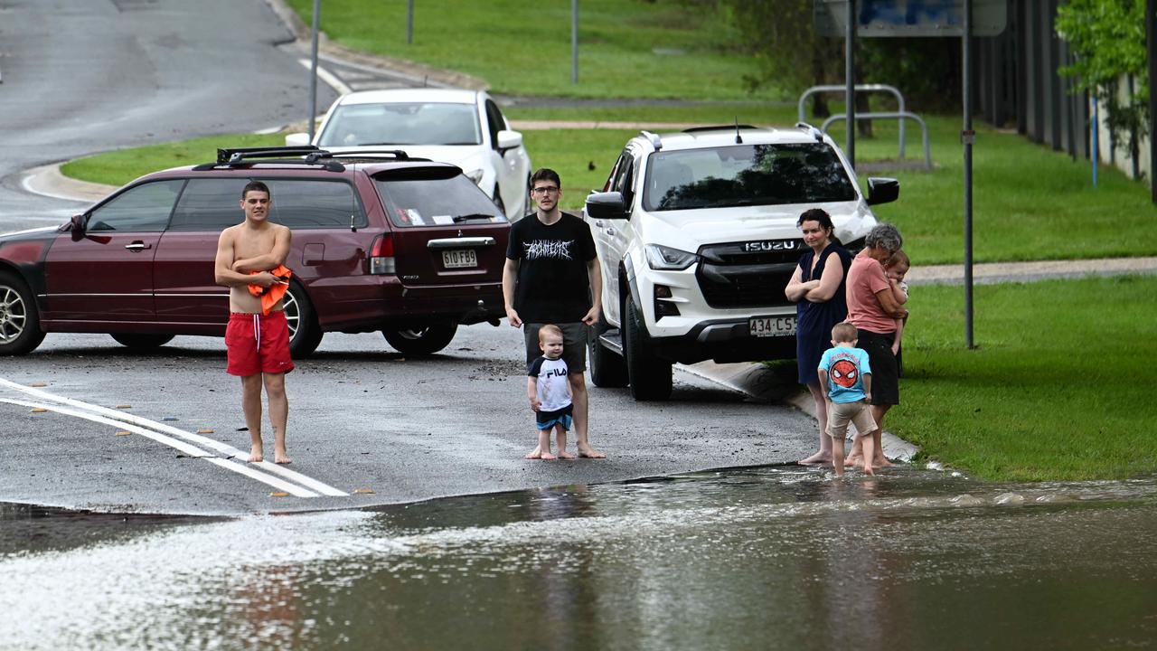 Residents look at the aftermath of heavy rain in the Springfield Lakes area. Picture: Lyndon Mechielsen/Courier Mail