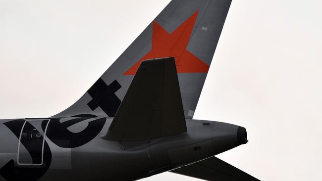 SYDNEY, AUSTRALIA - DECEMBER 12: A Jetstar aircraft tail is seen on arrival at Sydney airport on December 12, 2019 in Sydney, Australia. Jetstar has cancelled 108 upcoming flights between Friday and Sunday in preparation for pilots and ground staff to walk off the job for four hours on Saturday and Sunday amid stalled wage negotiations. (Photo by Sam Mooy/Getty Images)