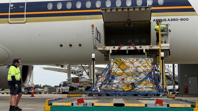 The first Australian shipment of Pfizer COVID-19 vaccines is unloaded from a Singapore Airlines plane at Sydney International Airport on Monday. Picture: Bianca De Marchi/AAP