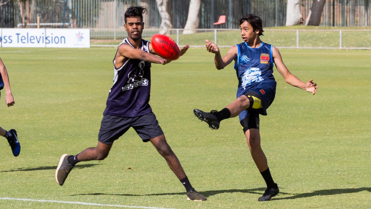 Caleb Franey from the Reclink Roos smothers a kick from Clontarf's Jai Harvey at Traeger Park Oval, Alice Springs. Picture: Emma Murray
